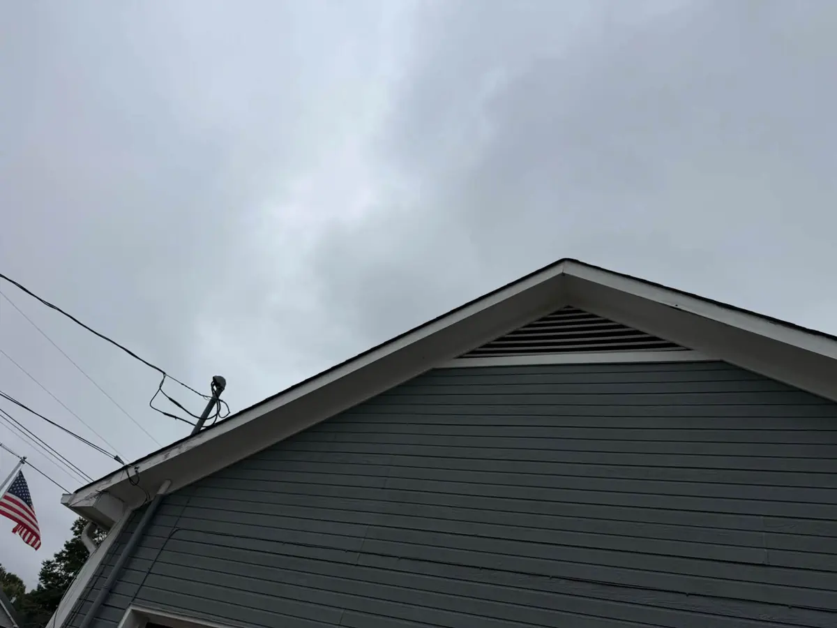 Gable peak with painted trim and vent